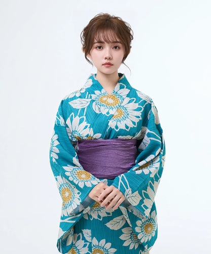 Woman wearing a blue floral kimono with a white background